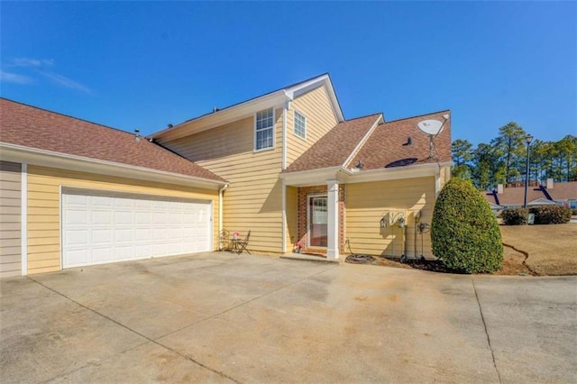 traditional home with driveway and an attached garage