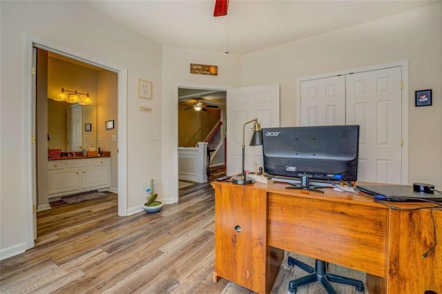 office featuring ceiling fan, light wood finished floors, and baseboards