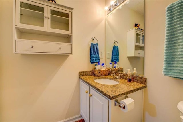 bathroom with vanity and baseboards