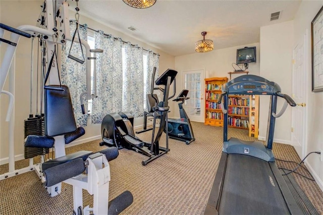 exercise room featuring carpet, visible vents, and baseboards