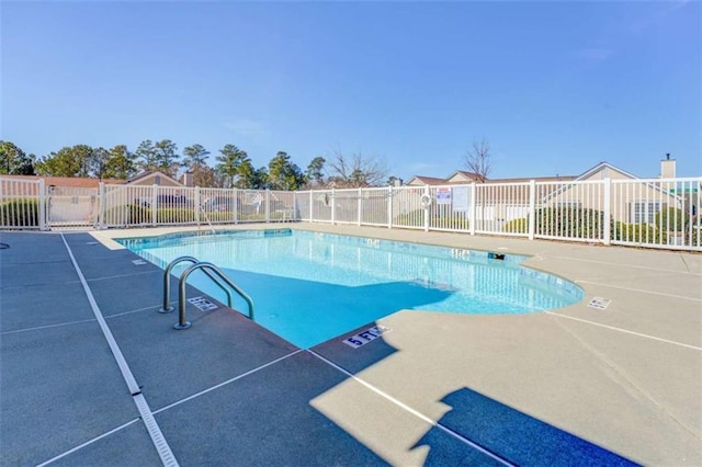 pool featuring a patio area and fence