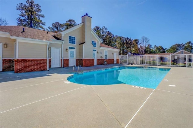 community pool featuring a patio and fence