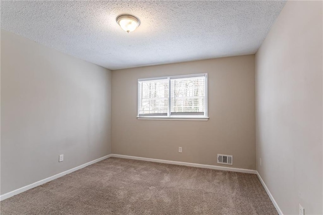 unfurnished room featuring a textured ceiling and carpet flooring