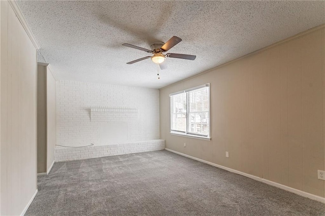 carpeted spare room with a textured ceiling and ceiling fan