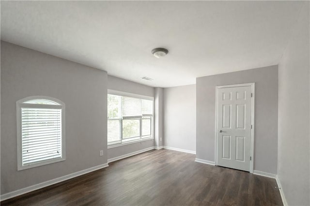 empty room with dark wood-type flooring