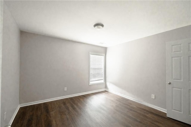 empty room with dark wood-type flooring