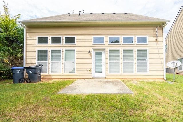 rear view of property with a lawn and a patio area