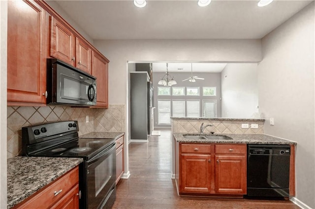 kitchen with sink, backsplash, black appliances, light stone countertops, and dark hardwood / wood-style flooring