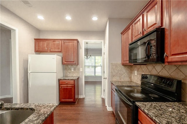 kitchen featuring black appliances, stone counters, dark hardwood / wood-style flooring, and sink