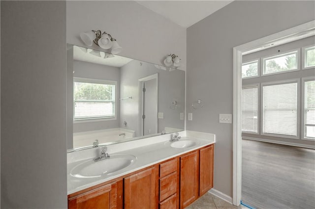 bathroom with vanity, a bathtub, and hardwood / wood-style flooring