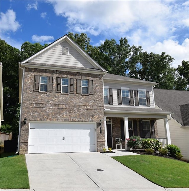 485 Broadmoor Dr, Braselton, GA 30517 - view of front of house with driveway, covered porch, a front lawn, and brick siding