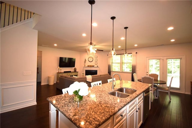 485 Broadmoor Dr, Braselton, GA 30517 - kitchen featuring a sink, a center island with sink, dark wood-type flooring, ceiling fan, and a fireplace
