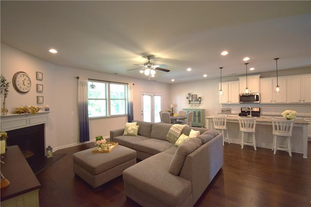 485 Broadmoor Dr, Braselton, GA 30517 - living area featuring recessed lighting, dark wood-type flooring, a ceiling fan, and a fireplace with raised hearth