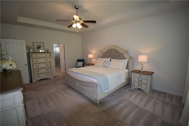 485 Broadmoor Dr, Braselton, GA 30517 - carpeted bedroom featuring a tray ceiling, ceiling fan, connected bathroom, and baseboards