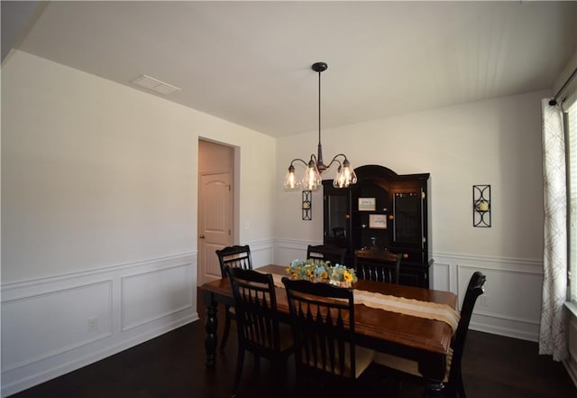 485 Broadmoor Dr, Braselton, GA 30517 - dining space featuring a chandelier, a wainscoted wall, a decorative wall, and dark wood-style floors