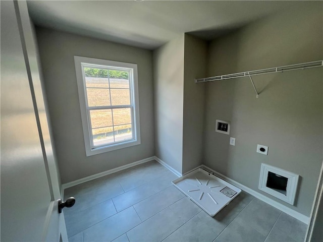 washroom with washer hookup, hookup for an electric dryer, and light tile patterned floors