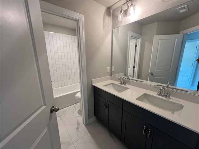 full bathroom with tiled shower / bath combo, vanity, and toilet