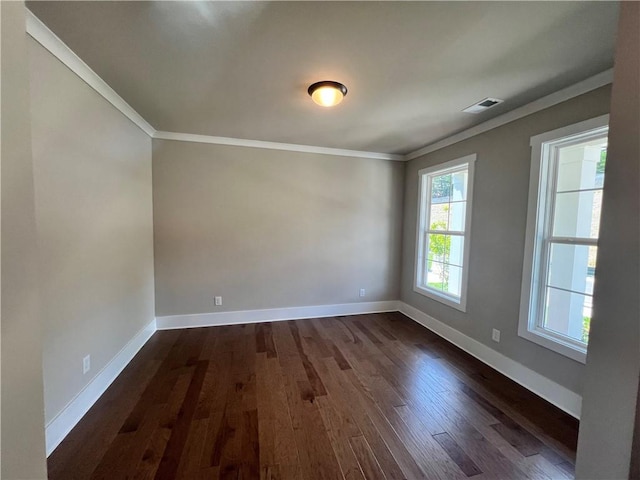 spare room with dark hardwood / wood-style floors and crown molding