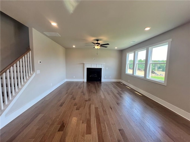 unfurnished living room with ceiling fan and dark hardwood / wood-style floors