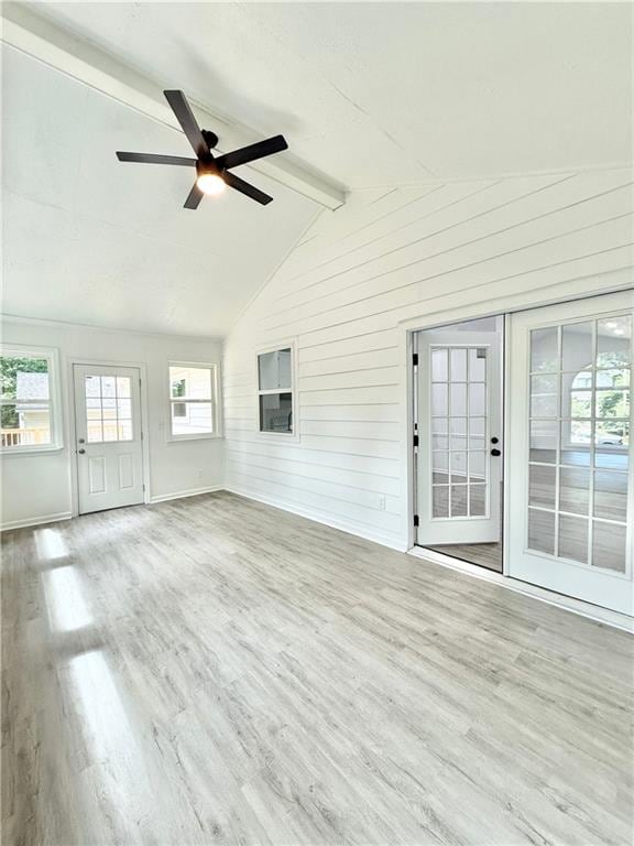 unfurnished sunroom with beamed ceiling and a healthy amount of sunlight