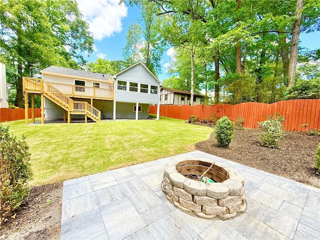 view of yard with an outdoor fire pit, a patio area, stairway, and a fenced backyard