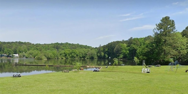 view of community featuring a water view and a forest view