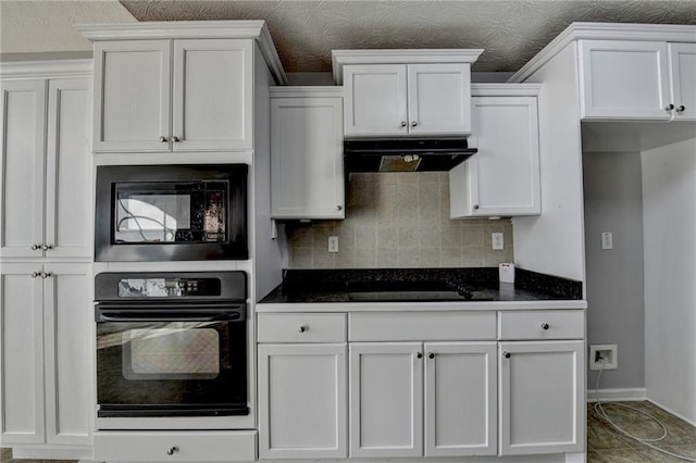 kitchen with white cabinets, black appliances, and extractor fan