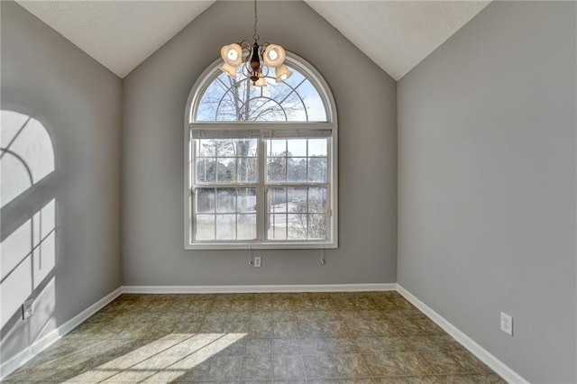 unfurnished room featuring lofted ceiling, baseboards, and an inviting chandelier