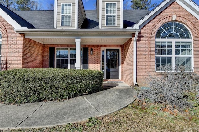 property entrance featuring brick siding