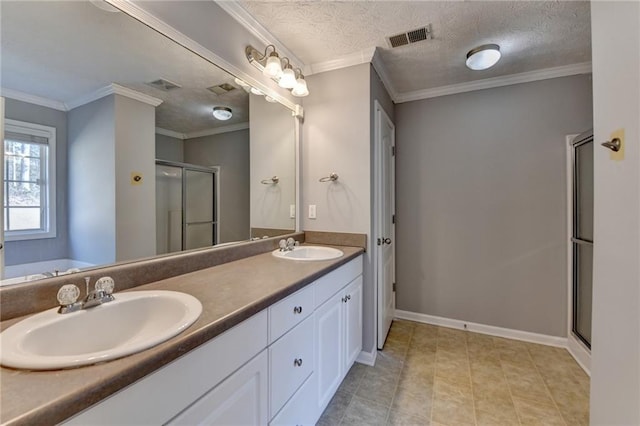 full bathroom featuring a shower stall, crown molding, visible vents, and a sink