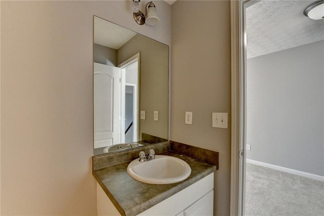 bathroom featuring baseboards and vanity