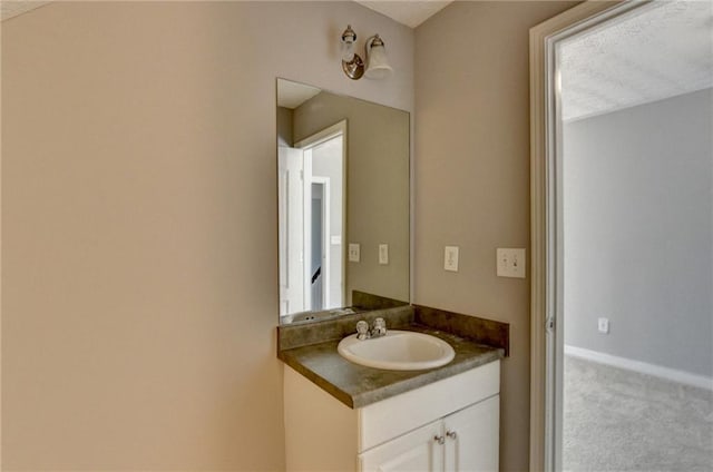 bathroom with vanity and baseboards