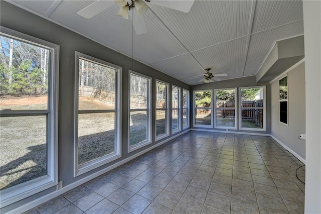 unfurnished sunroom with ceiling fan