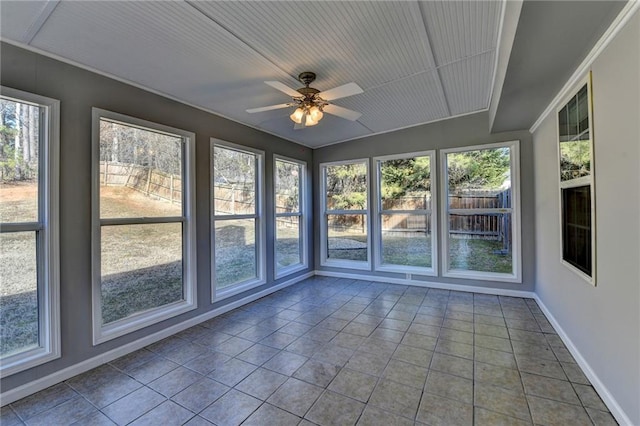 unfurnished sunroom featuring ceiling fan