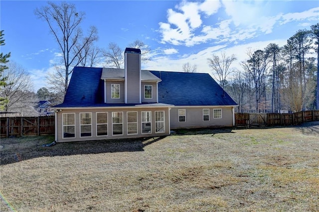 back of house with fence and a chimney