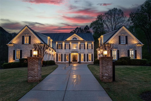 colonial inspired home with a yard