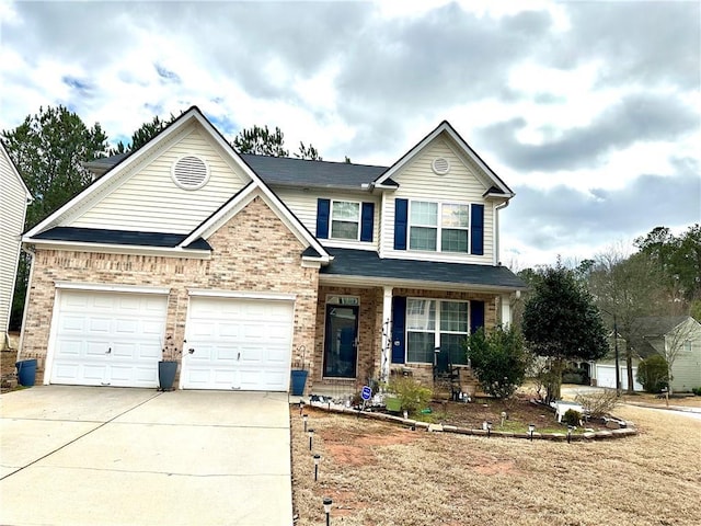 view of front of house featuring a garage, brick siding, and driveway