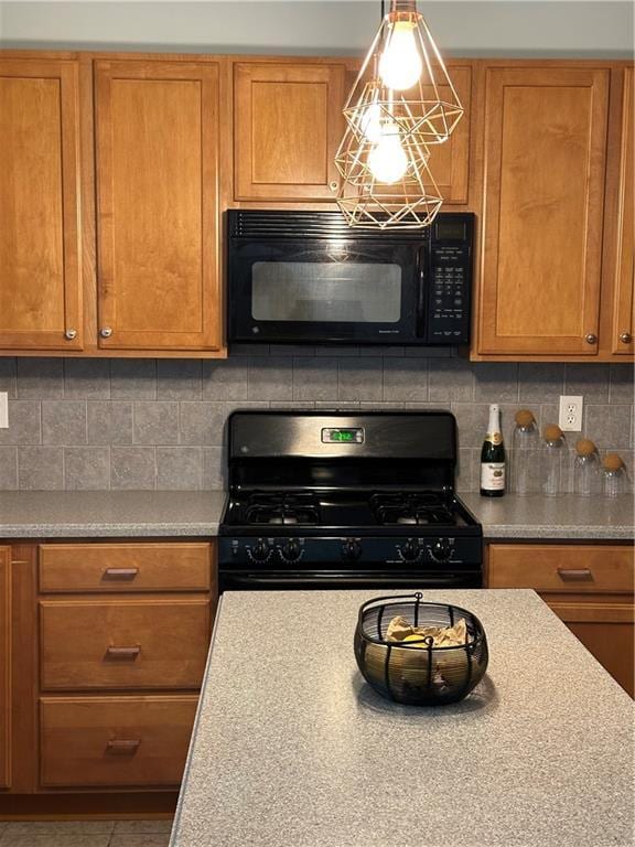 kitchen featuring black appliances, tasteful backsplash, and brown cabinets