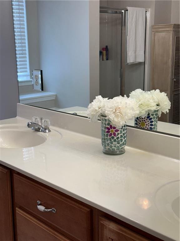 bathroom featuring a shower stall and vanity