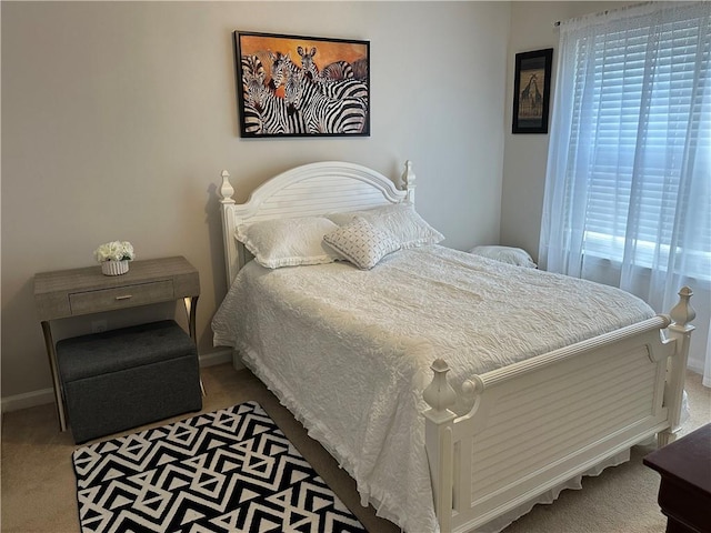 carpeted bedroom with baseboards