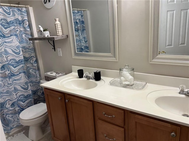 full bathroom with double vanity, a sink, and toilet