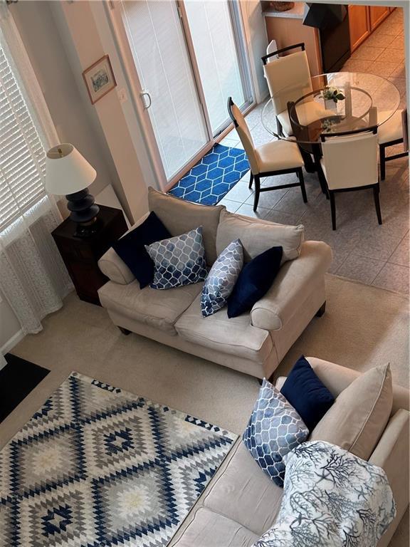 living room featuring light tile patterned flooring and plenty of natural light