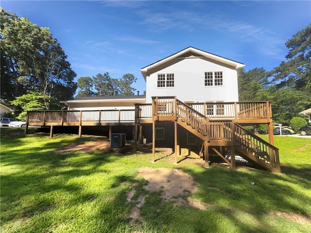 back of house featuring a lawn, a deck, and central AC unit