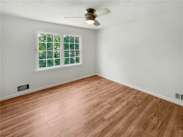 spare room featuring ceiling fan and light hardwood / wood-style floors