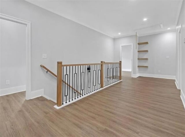 interior space with baseboards, recessed lighting, wood finished floors, and an upstairs landing