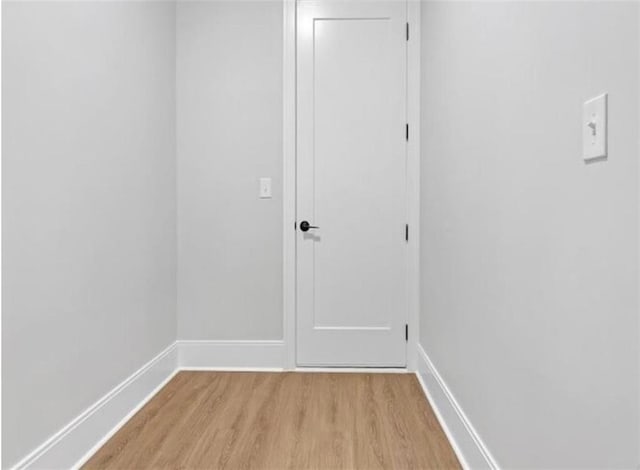 interior space with baseboards and light wood finished floors