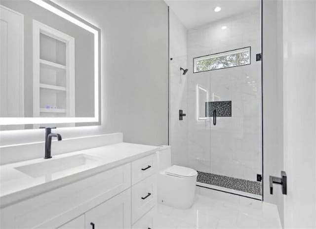 bathroom with vanity, marble finish floor, toilet, recessed lighting, and a marble finish shower