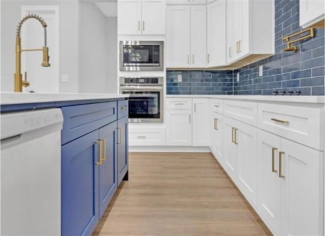 kitchen with white cabinetry, appliances with stainless steel finishes, and decorative backsplash