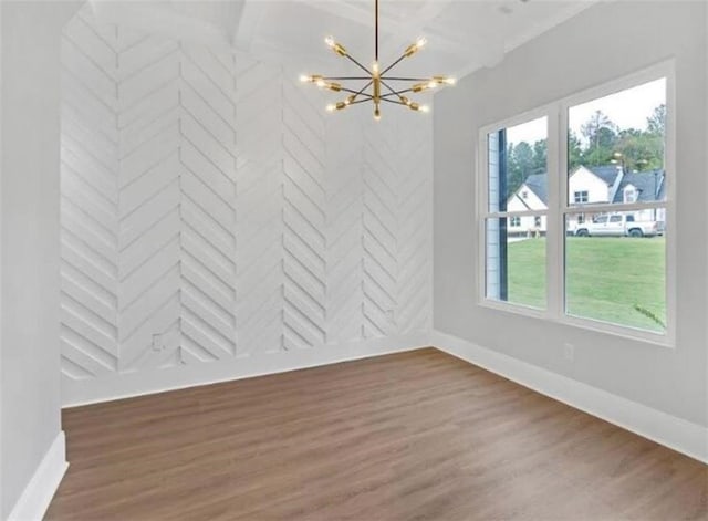 unfurnished dining area featuring baseboards, beamed ceiling, wood finished floors, and a chandelier