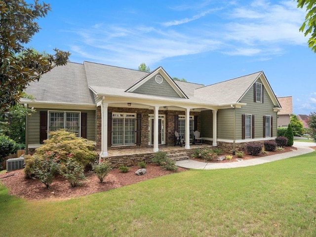 view of front of home featuring central air condition unit and a front yard